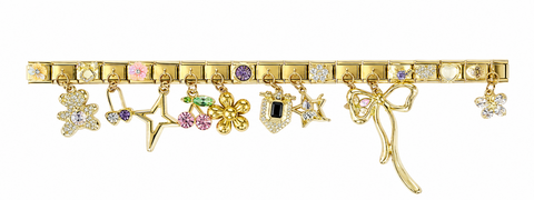 A gold-toned charm bracelet featuring multiple dangling charms, including stars, flowers, a fairy, and a wand, embellished with small colorful gemstones, shown against a plain white background.